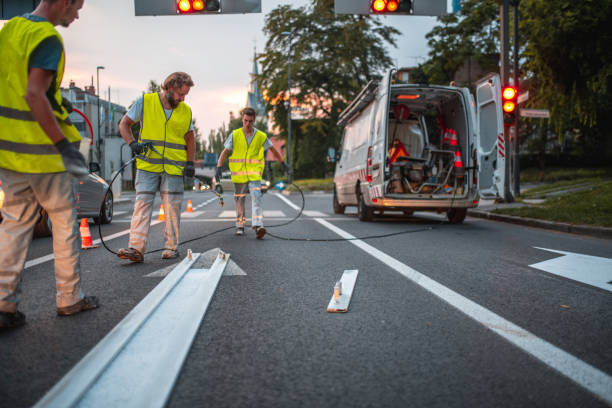 istock Group Of Workers Repainting The Road 1420990556
