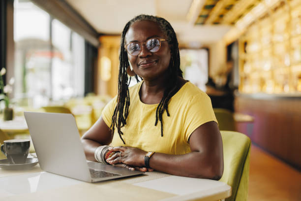 istock Confident business owner working her a cafe 1420991626