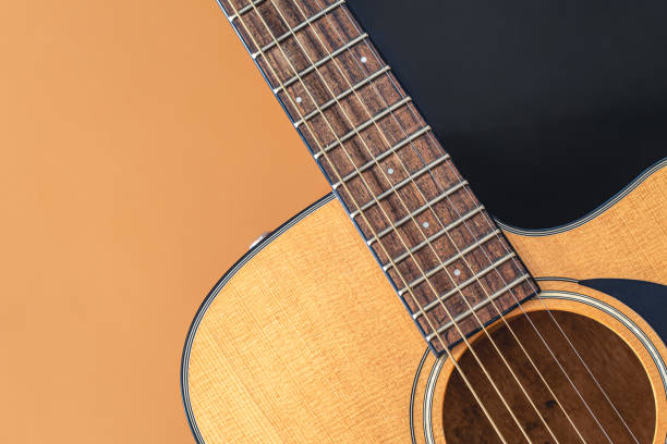 istock Acoustic guitar close-up on a colored background, flat lay. 1420992576