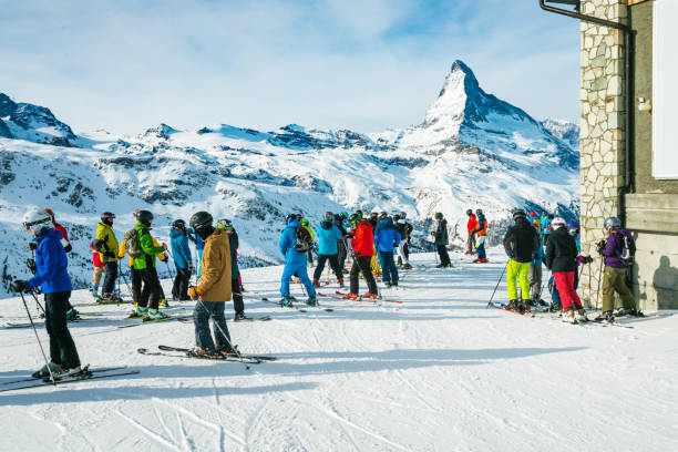 Skiers looking at Matterhorn mountain at Zermatt ski resort, Switzerland stock photo