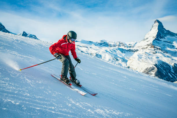 Young skier downhill skiing at Zermatt ski resort, Switzerland stock photo