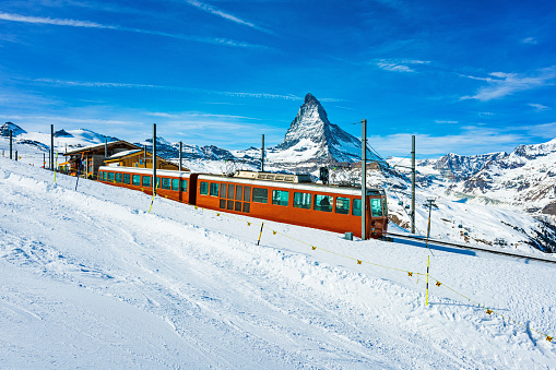 Train on Gornergrat cog railway above Zermatt town in Mattertal, Valais canton, Switzerland, in winter. Matterhorn mountain peak in background. Taken by Sony a7R II, 42 Mpix.