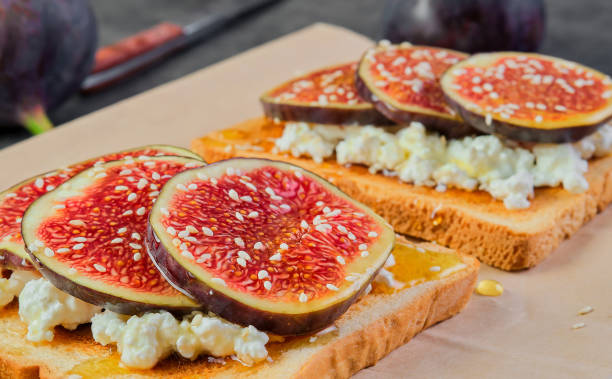 istock Toast with figs honey and ricotta cheese, close-up. Selective focus on bruchetta, breakfast idea or photo for menu, mediterranean breakfast 1420998124