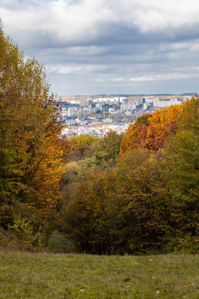 istock autumn is coming yellow trees park city on background 1420998544