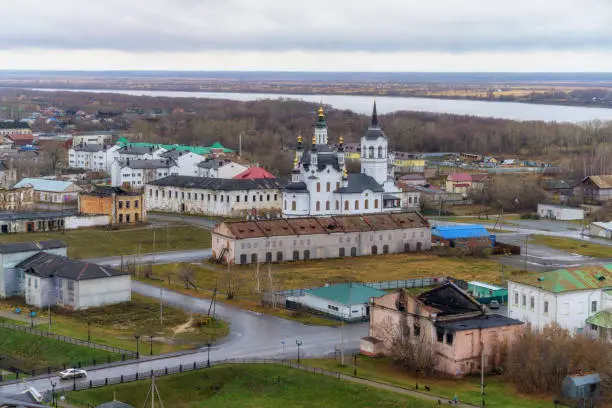 Bird's eye view of the city of Tobolsk (Siberia, Russia) on a cloudy autumn day. The ancient buildings have not yet been fully restored; a tall golden-domed church and the Irtysh river are visible