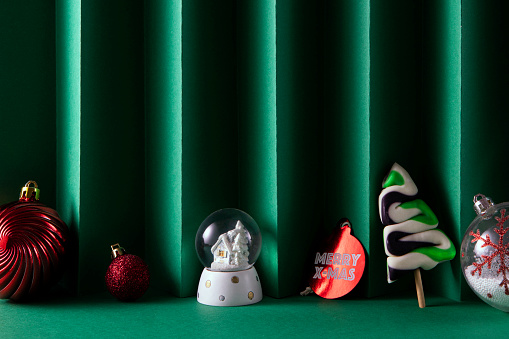 Christmas ornaments on green background