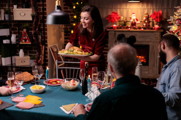 istock Family gathering at christmas dinner table 1421002617