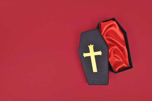 Coffin shaped Halloween cardboard gift box on red background with copy space