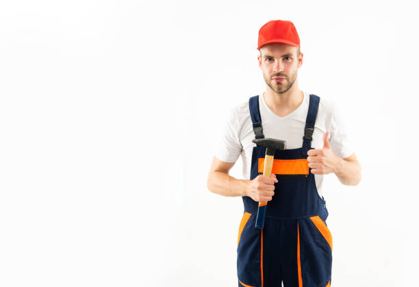 istock man in builder uniform hold hammer isolated on white background, copy space, repair 1421006452