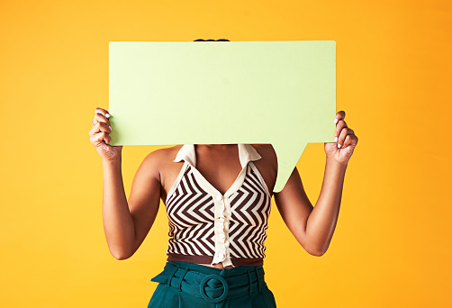 Mockup of marketing speech bubble sign for social media in hand, advertising communication and feedback on review on mock up studio background. Person with work news and chatting in conversation