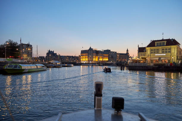 istock Amsterdam cityscape at night view from boat 1421008300