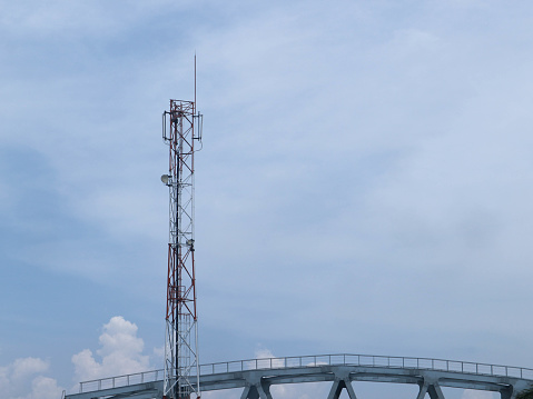 Cellular and Internet tower with antennas on the bright sky