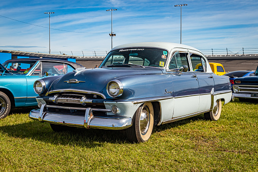 Daytona Beach, FL - November 24, 2018: Low perspective front corner view of a 1954 Plymouth Savoy Sedan at a local car show.