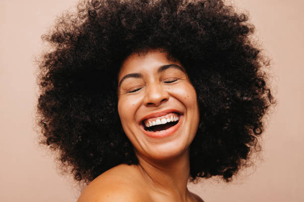 istock Woman with Afro hair laughing happily in a studio 1421013828