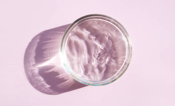 istock petri dish with liquid water on pink background water ripple texture 1421014924