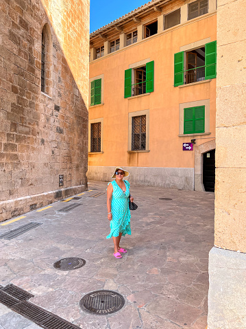 Attractive Hispanic senior in old town alleyway of Spanish city of Palma