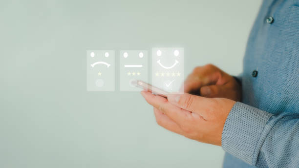 istock Customer Service Assessment Concept.Users rate the service of an online application. Businessman presses smiley face showing emoticon on virtual screen, survey, user experience questionnaire or customer satisfaction research. 1421017726