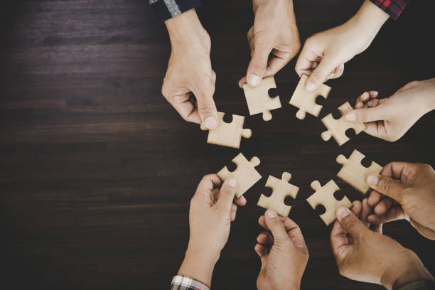 istock young business people putting their hands together 1421017822