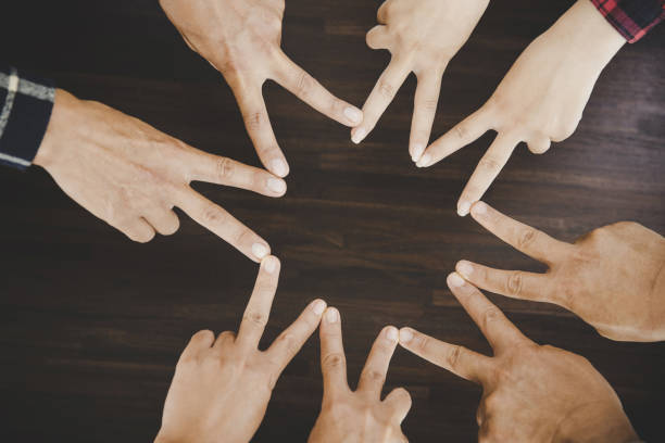 istock young business people putting their hands together 1421018681