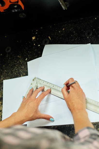 istock Female interior designer working on drawings, woman architect draws 1421019783