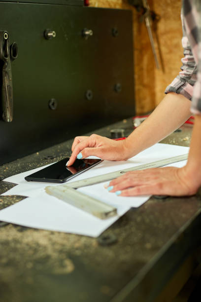istock Female business owner using digital tablet in workshop 1421019788