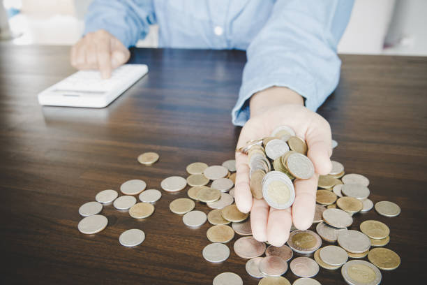 istock a woman makes calculations, checks her finances, makes notes in a notebook 1421020349