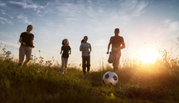 istock Happy family playing soccer 1421020376