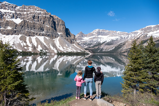 Mother and her children enjoy the views over Peyto Lake in the Rocky Mountains in Canada. Top tourist attractions while visiting the Banff National Park