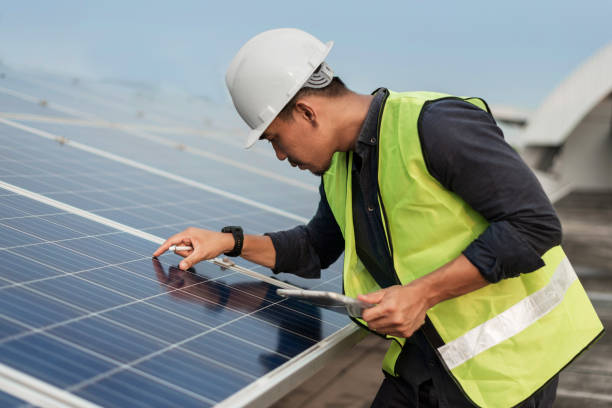 istock Engineer man checking of solar panels energy with tablet.  Technician checking and services of photovoltaic solar panels.  Sustainable Energy concept. 1421023527
