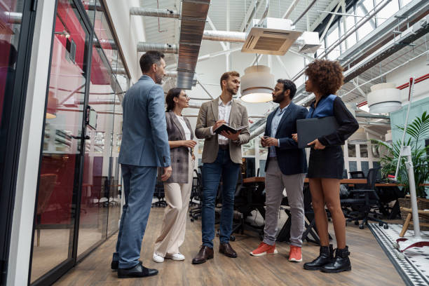 istock Multiethnic group of business people talking in office during break. Teamwork concept 1421023547
