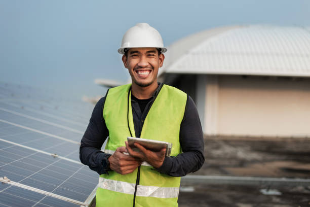 istock Engineer man checking of solar panels energy with tablet.  Technician checking and services of photovoltaic solar panels.  Sustainable Energy concept. 1421023557