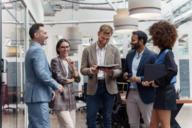 istock Multiethnic group of business people talking in office during break. Teamwork concept 1421023645