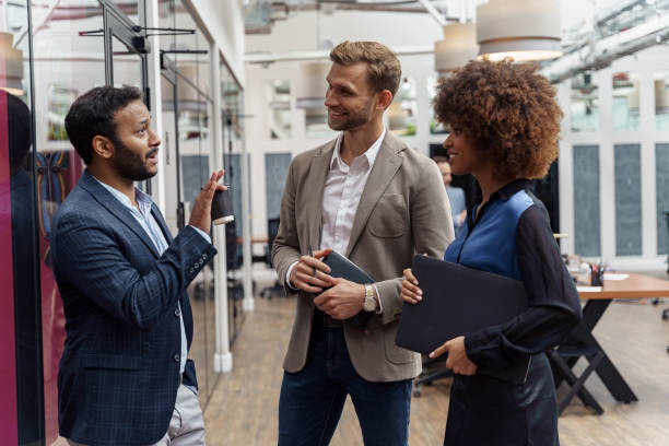 istock Multiethnic group of business people talking in office during break. Teamwork concept 1421023684