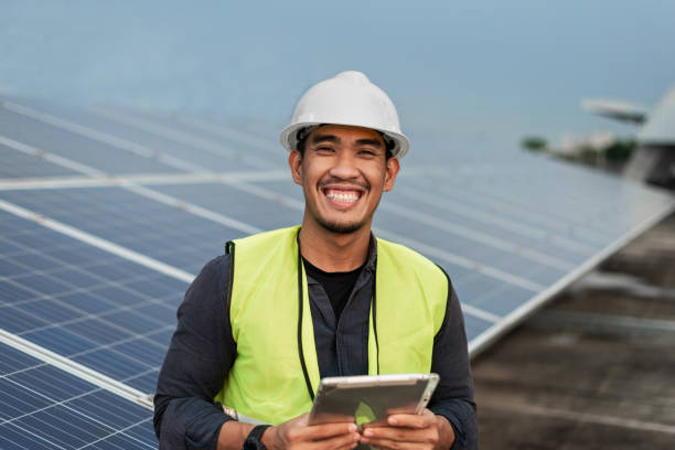 istock Engineer man checking of solar panels energy with tablet.  Technician checking and services of photovoltaic solar panels.  Sustainable Energy concept. 1421023826