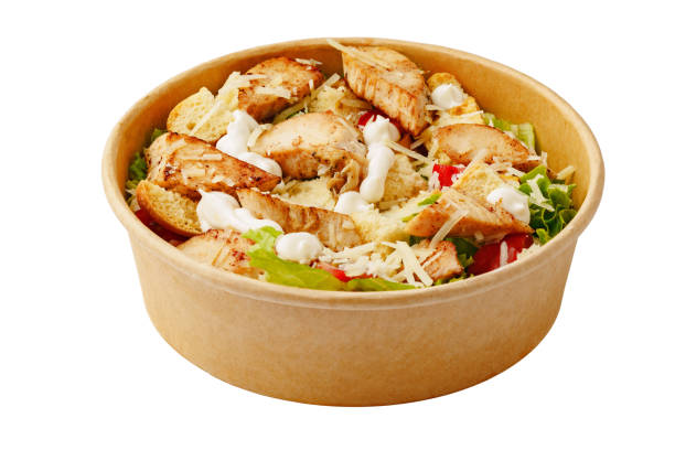 istock Plate of chicken caesar salad isolated on white background 1421024967