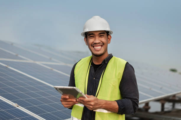 istock Engineer man checking of solar panels energy with tablet.  Technician checking and services of photovoltaic solar panels.  Sustainable Energy concept. 1421024999