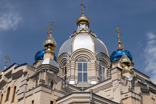 Golden domes of an Orthodox church with crosses close-up