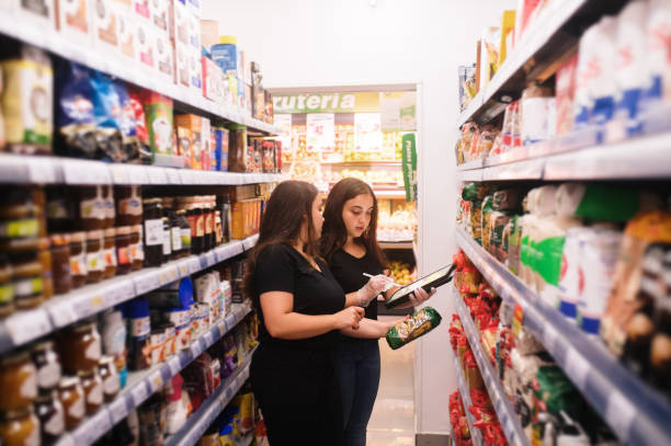 istock Two women working with a tablet in a grocery store 1421026073