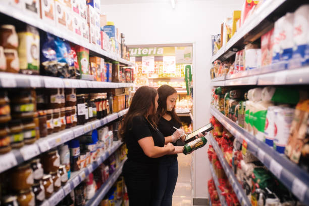 istock Two women working with a tablet in a grocery store 1421026079