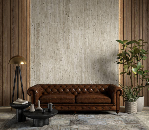 istock Interior with brown leather chester sofa, stone wall panel, backlight, plants and decor. 3d render illustration mockup. 1421026116