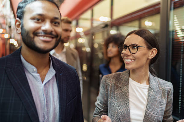 istock Multiethnic group of business people talking in office during break. Teamwork concept 1421027444