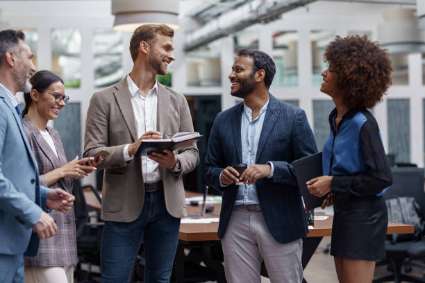 istock Multiethnic group of business people talking in office during break. Teamwork concept 1421028522