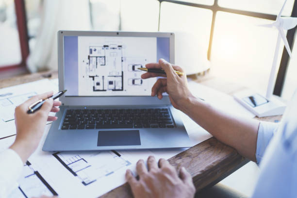 istock Construction and structure concept of engineer working drawing on blueprint meeting for project working with partner on model building and engineering tools in working site, construction concept 1421030314
