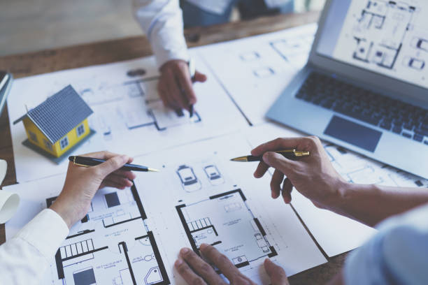 istock Construction and structure concept of engineer working drawing on blueprint meeting for project working with partner on model building and engineering tools in working site, construction concept 1421030331