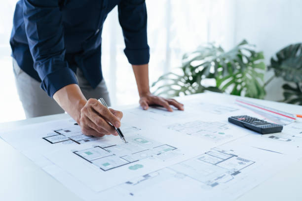 Close-up, architects team are brainstorming, designing and drawing the structure of the building. Close-up, architects team are brainstorming, designing and drawing the structure of the building. architect stock pictures, royalty-free photos & images