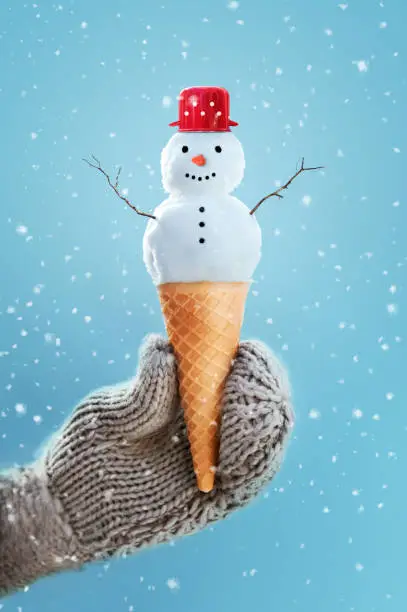 Photo of Snowman in an Ice cream cone, cute winter-summer concept