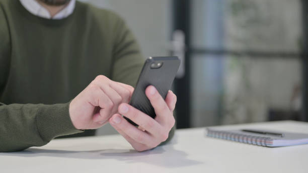 istock Close up of Young Businessman using Smartphone 1421032885