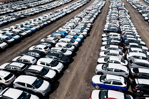 Tamworth, UK - August 30, 2022.  An aerial view of rows of newly built cars and vehicles ready for export and import and delivery to sales dealerships on a shipping dock