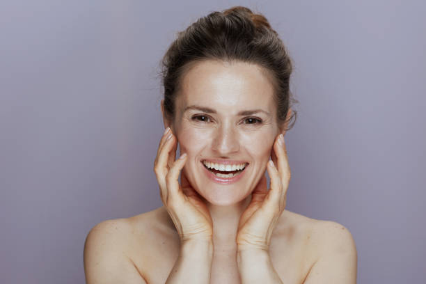 istock happy young woman on blue 1421036371