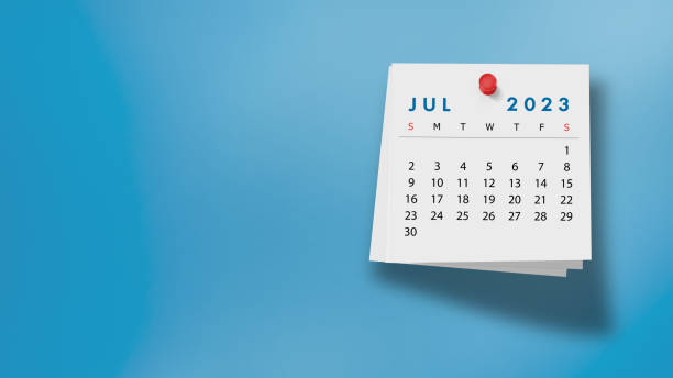 2023 July Calendar on Note Pad Against Blue Background 2023 July calendar on a white note paper pinned on wall against blue background. High resolution and copy space for all your crop needs. july stock pictures, royalty-free photos & images